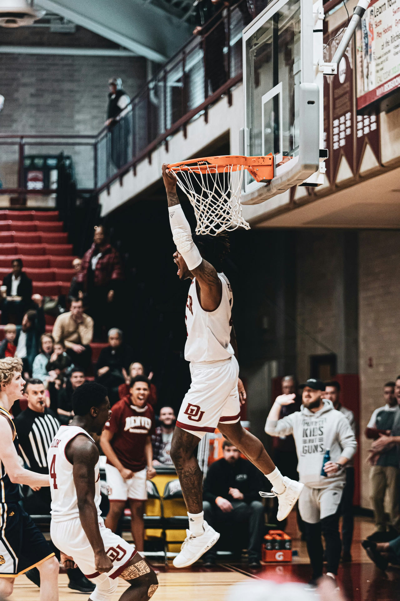 Basketball player dunking with crowd celebrating